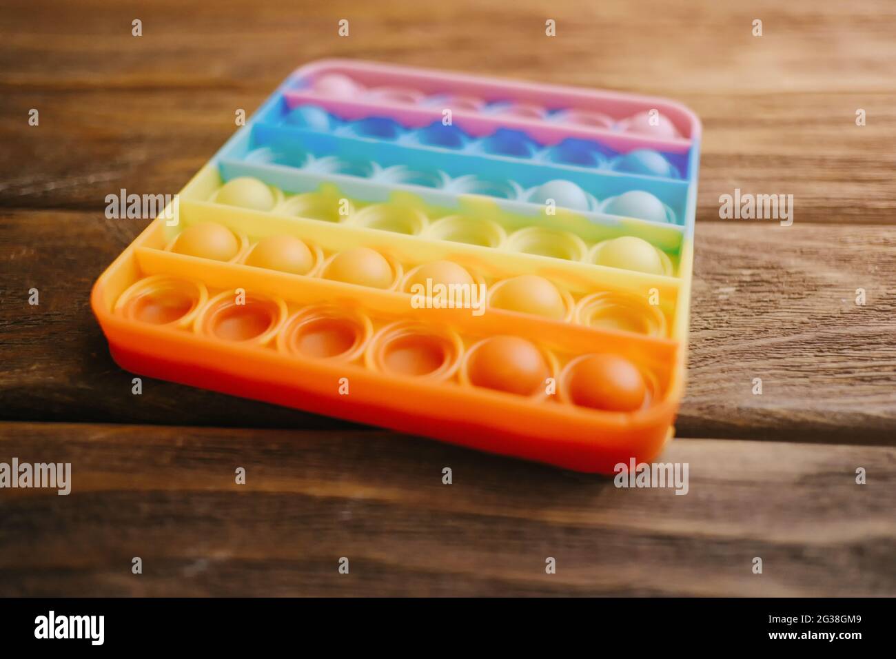 Popular children's toy 'simple dimple' on a wooden table close-up. Stock Photo