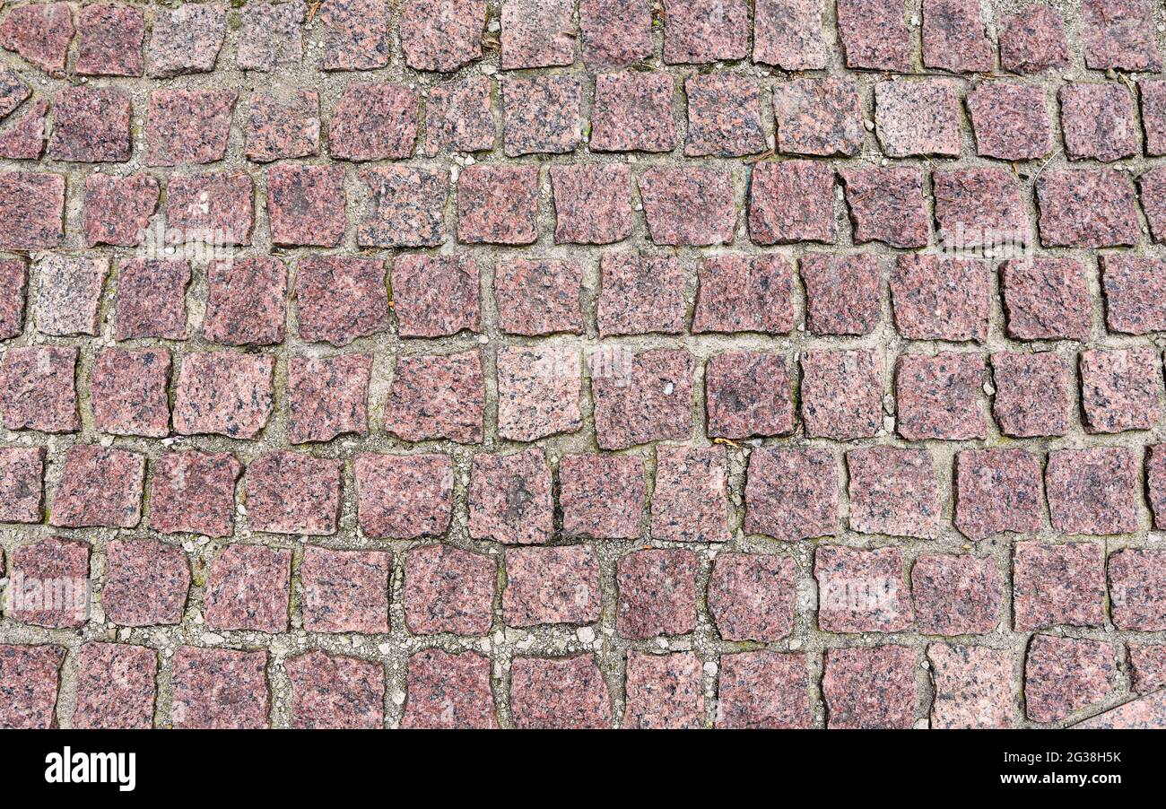Old cobblestone pavement close-up. Pavement texture. Stock Photo
