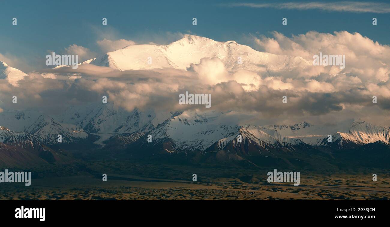 Evening view of Lenin Peak from Alay range - Kyrgyz Pamir Mountains - Kyrgyzstan and Tajikistan border- Central Asia 'Roof of the World' Stock Photo