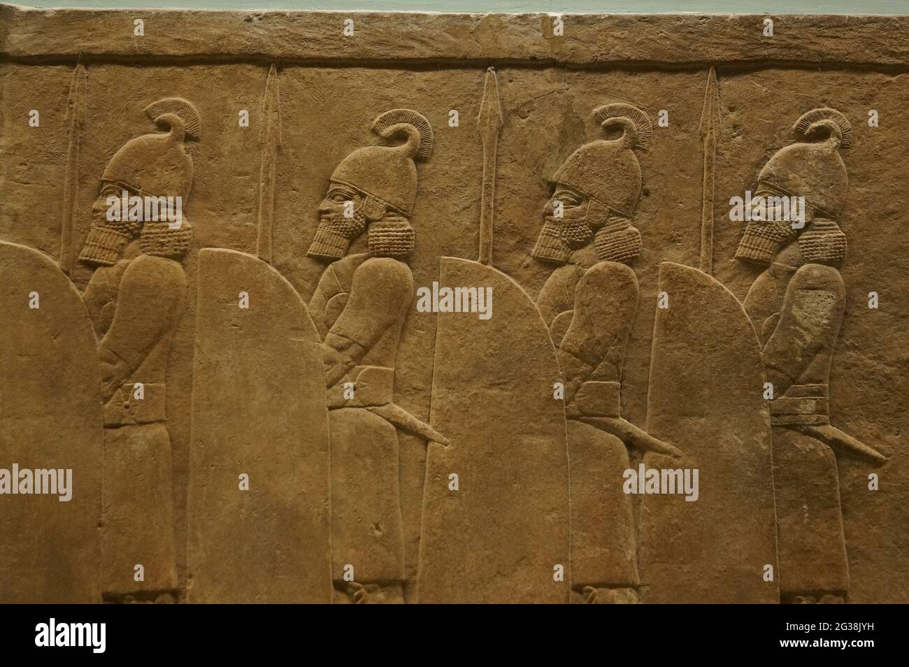 London, UK: detail of an Assyrian alabaster bas-relief with soldiers, held at the British Museum Stock Photo