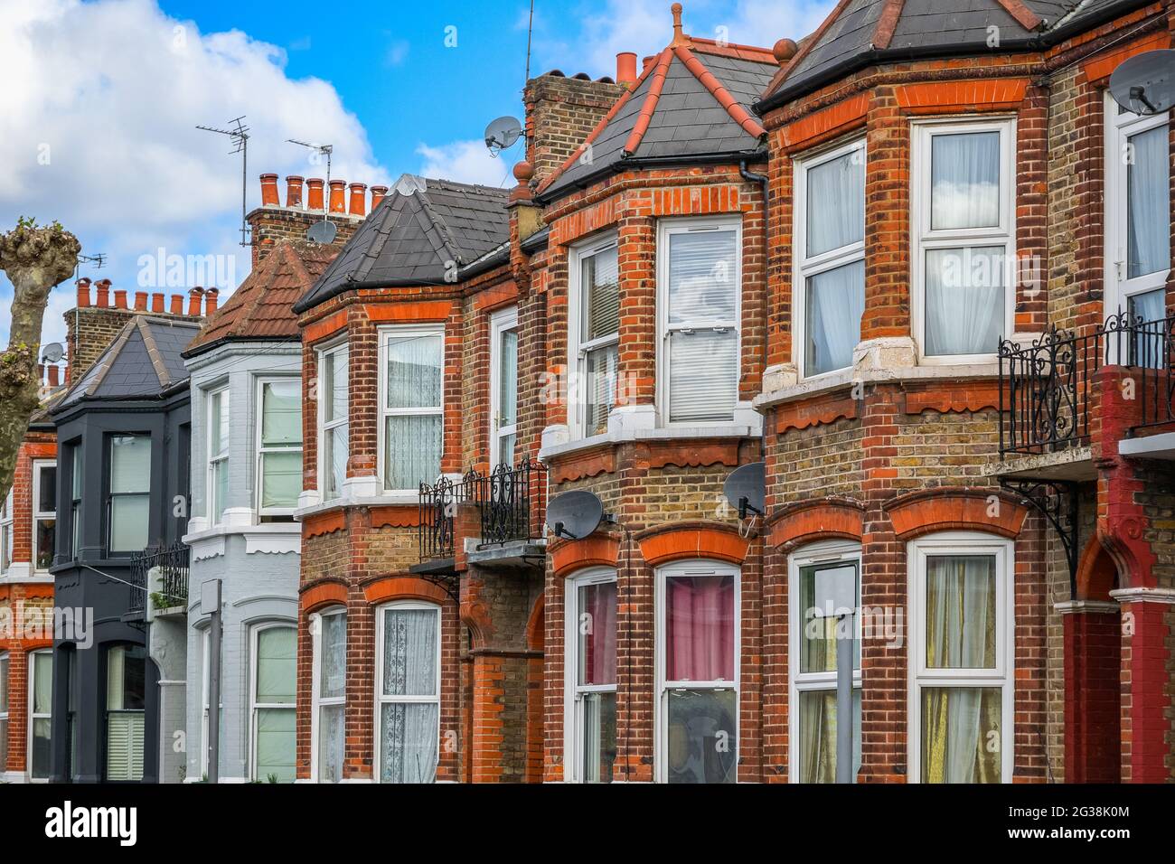 A row of typical red brick English terraced houses around
