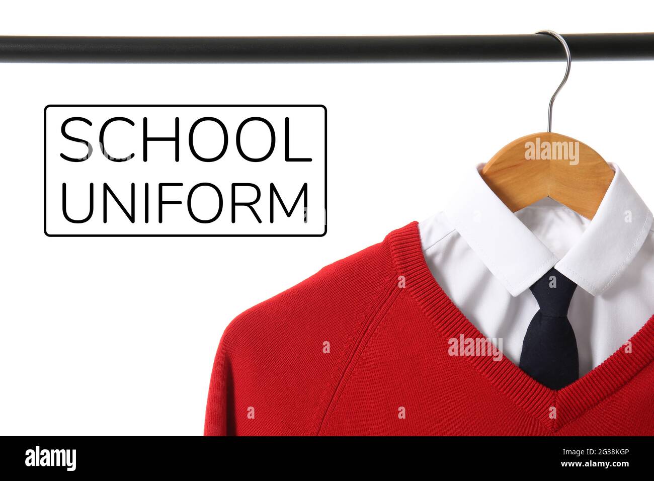 Stylish school uniform hanging on rack against white background Stock