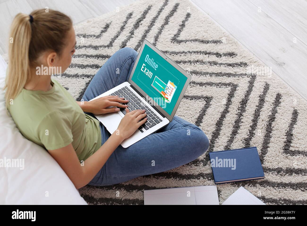 Woman with laptop passing exams online at home Stock Photo