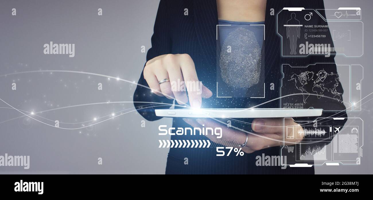 Recognition and scanning to ensure personal safety. White tablet in businesswoman hand with digital hologram fingerprint scanning sign on grey backgro Stock Photo