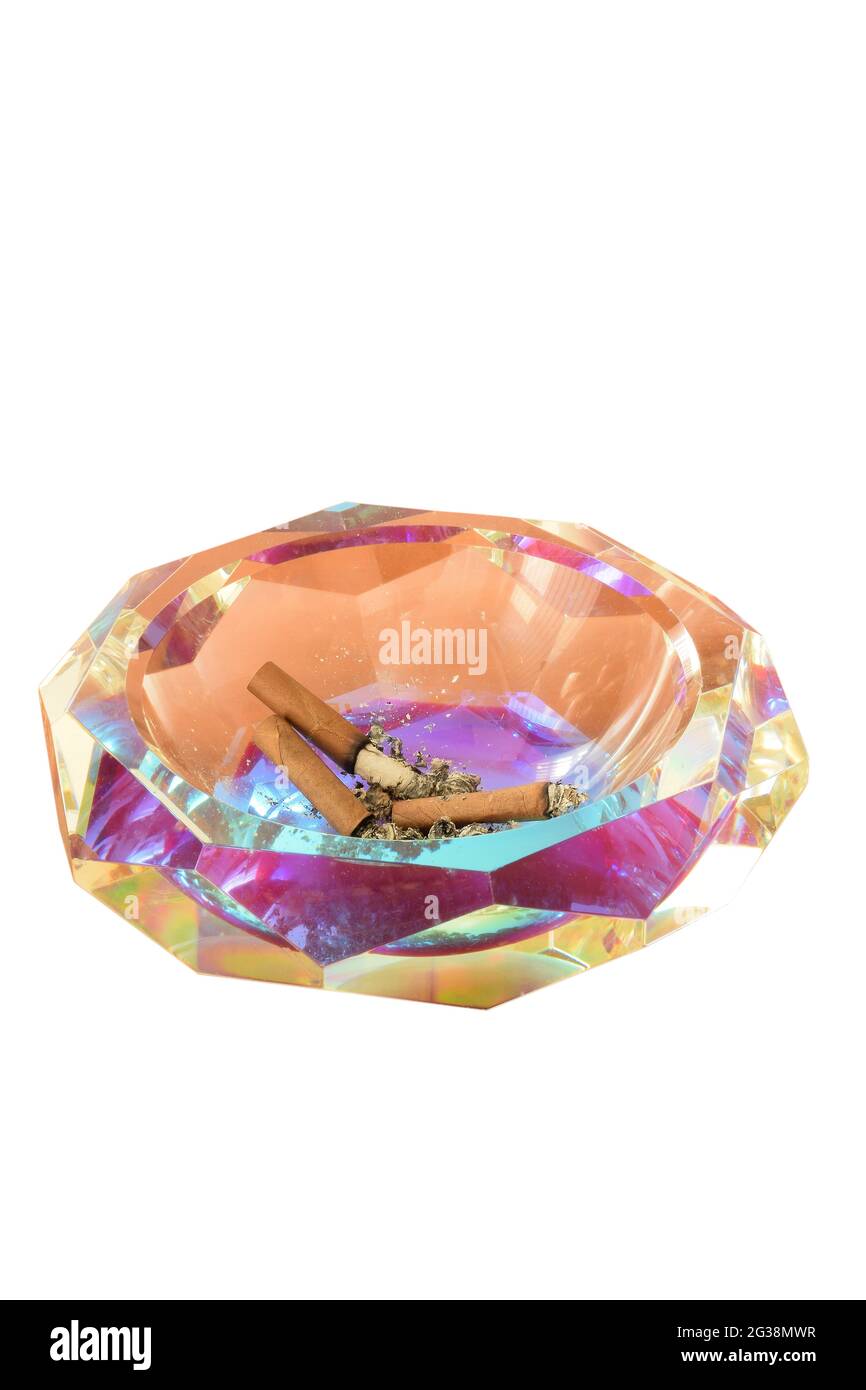 Glass cut ashtray with extinct cigars and ashes on white clipping background Stock Photo