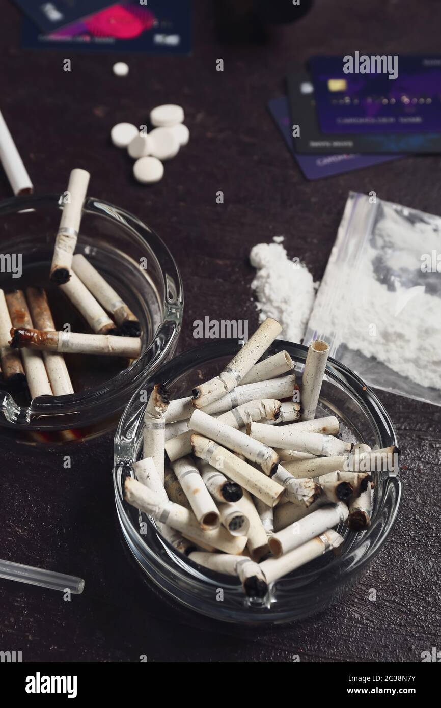 cigarettes drugs Drugs and cigarettes on dark background. Concept of addiction Stock Photo