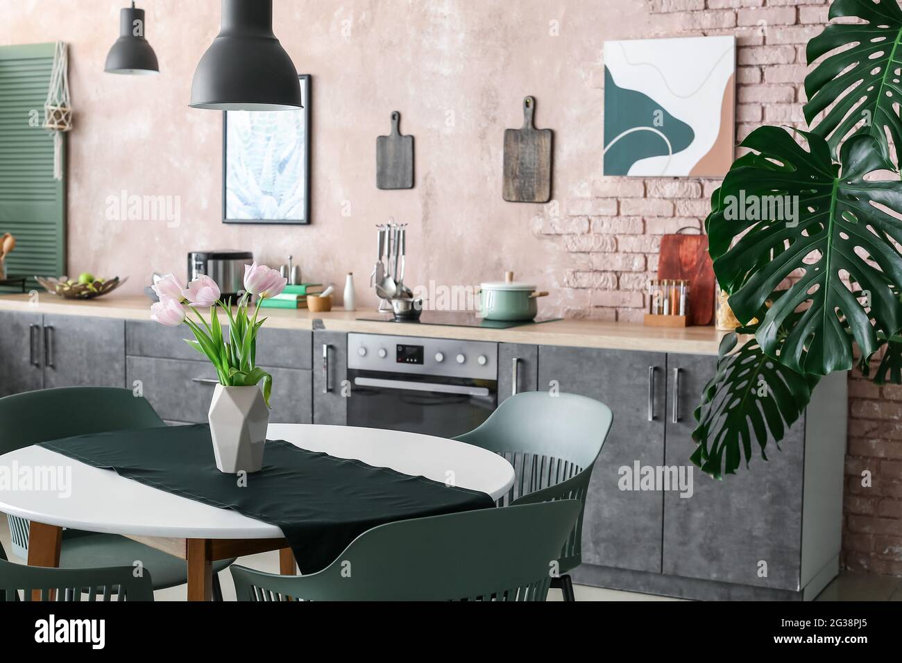 Interior of stylish modern kitchen with dining table Stock Photo - Alamy