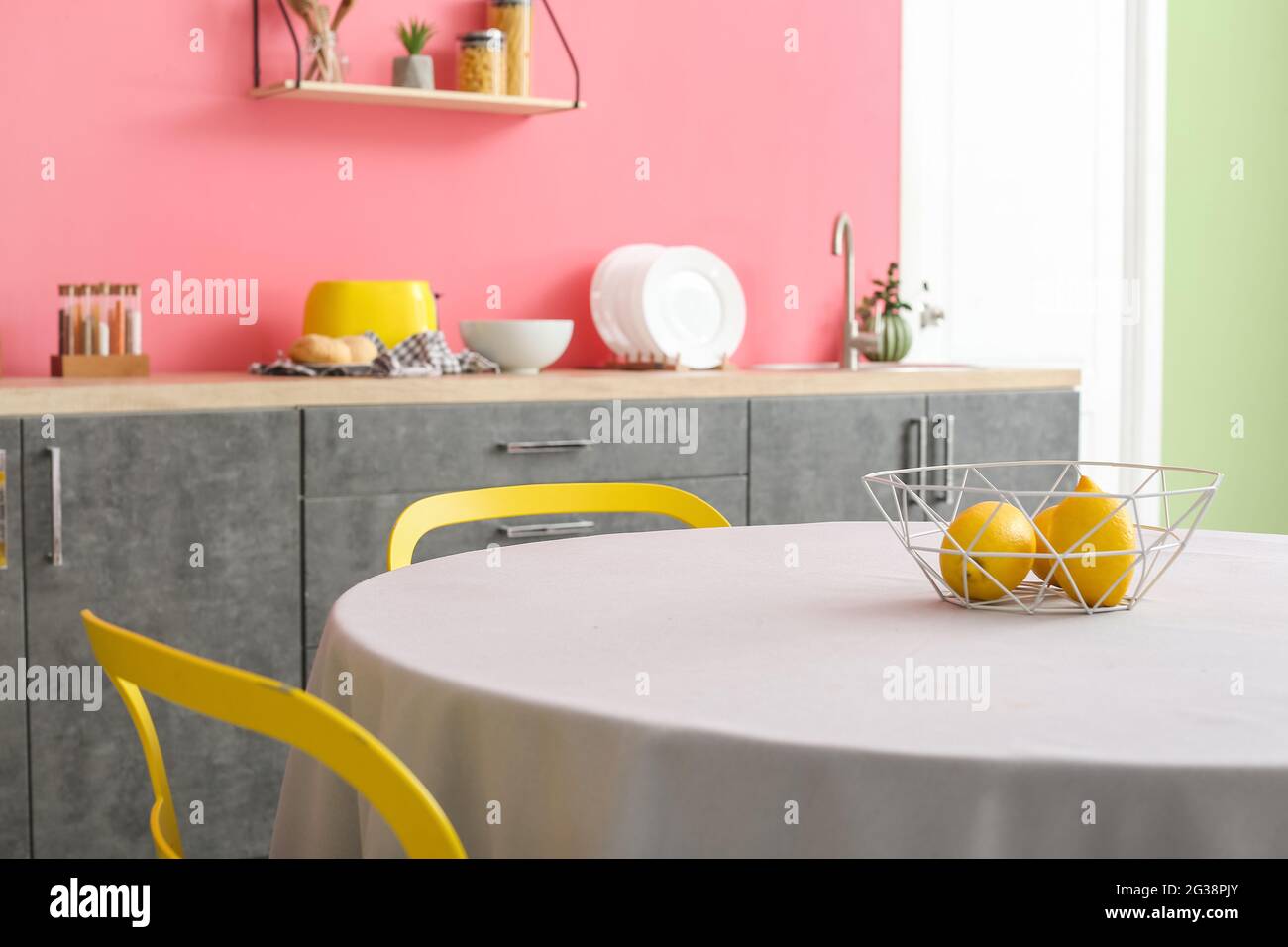 Interior of stylish modern kitchen with dining table Stock Photo - Alamy