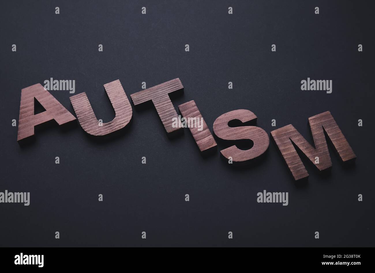 Word AUTISM on dark background Stock Photo - Alamy