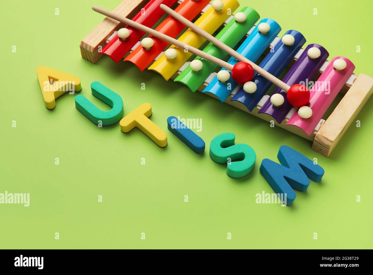 Word AUTISM and xylophone on color background Stock Photo - Alamy