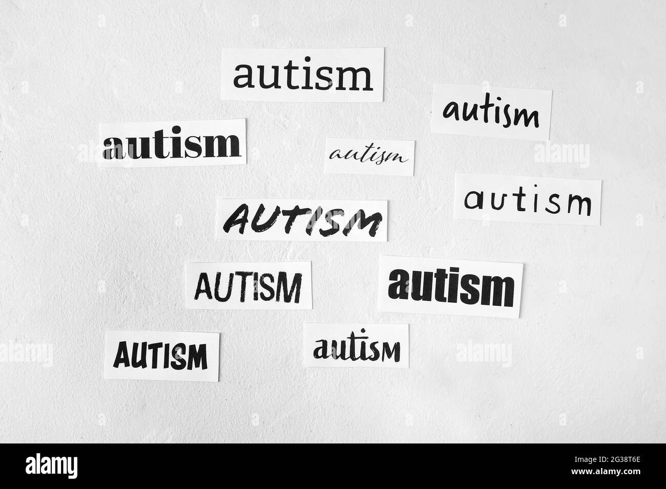 Pieces of paper with words AUTISM on white background Stock Photo