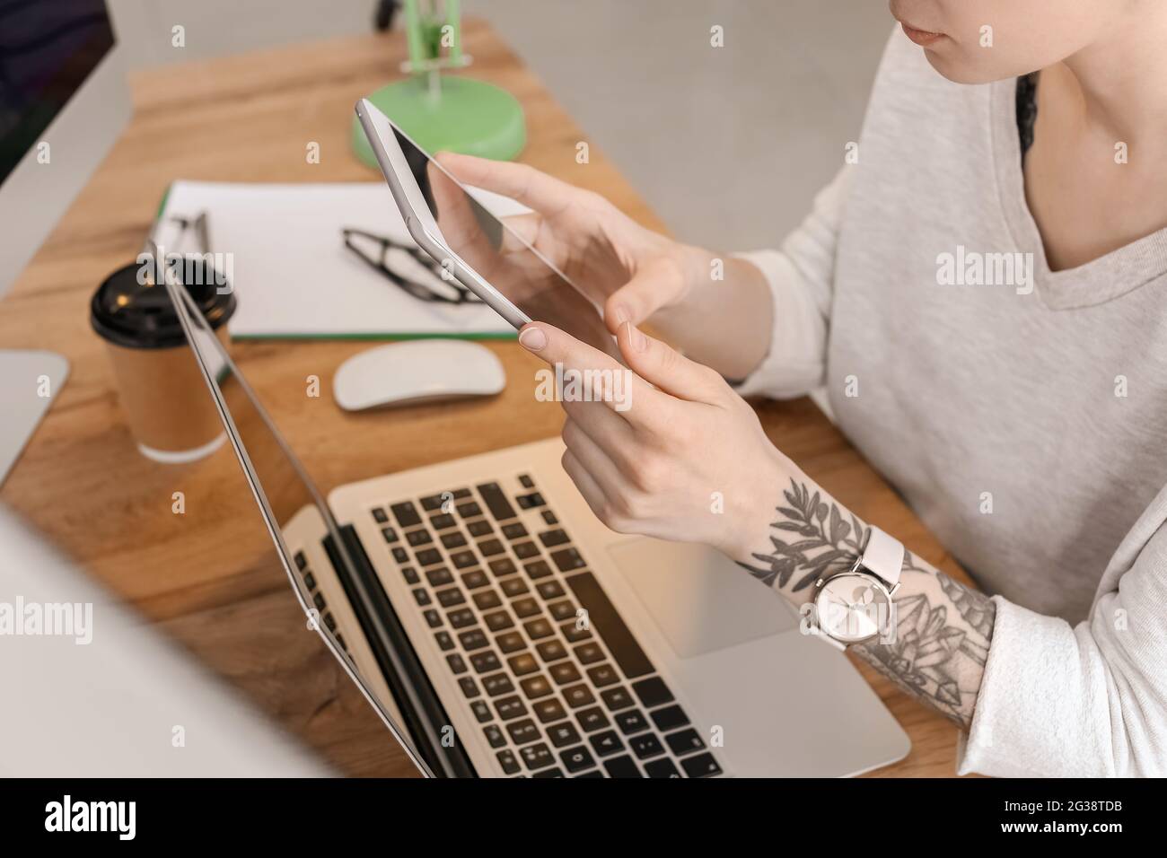 Female programmer using tablet computer in office, closeup Stock Photo