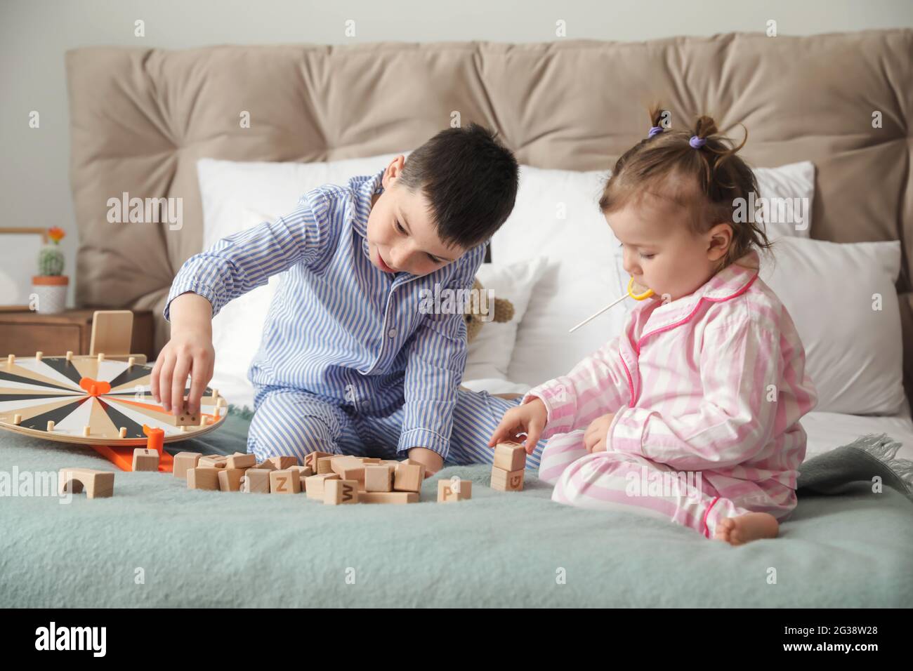 Cute little children playing with toys in bedroom Stock Photo - Alamy