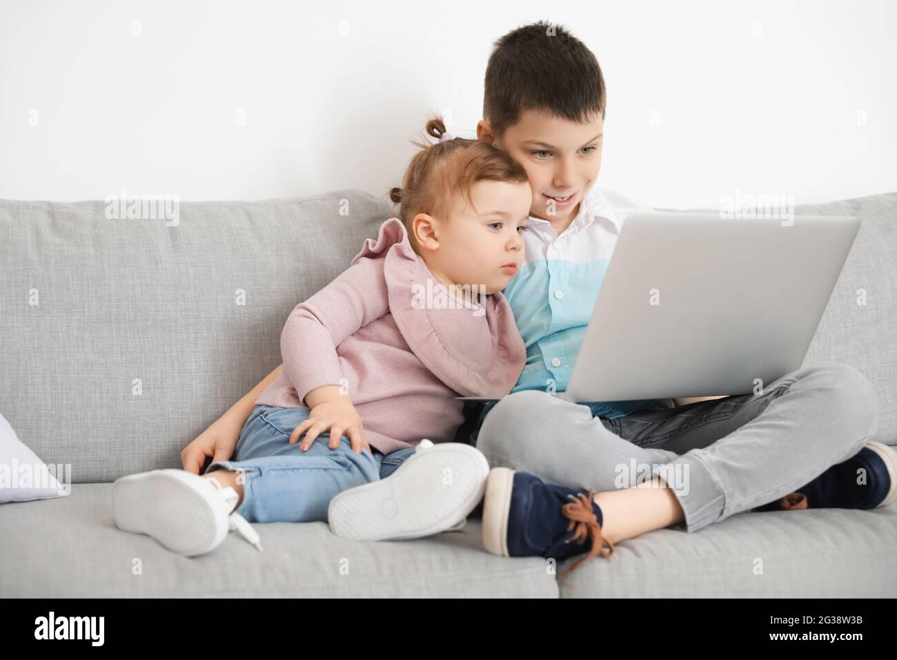 Cute little children using laptop at home Stock Photo - Alamy