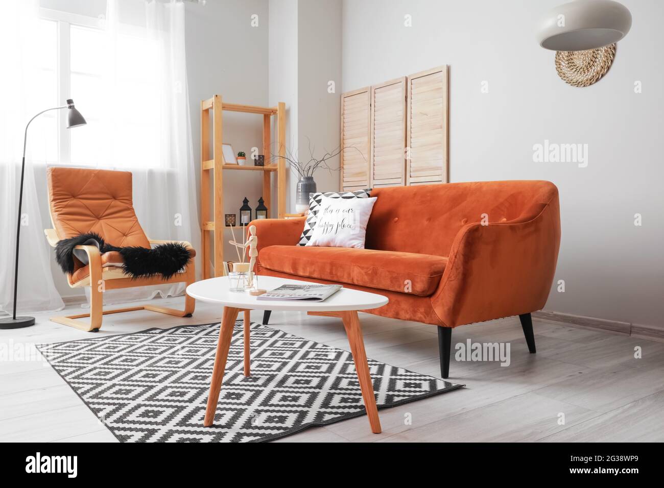Interior of living room with stylish sofa Stock Photo - Alamy