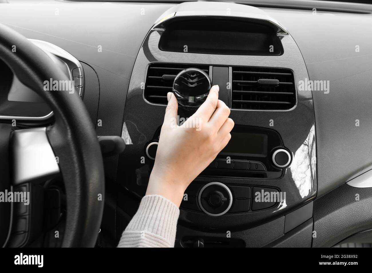 Female hand with air freshener hanging in car Stock Photo