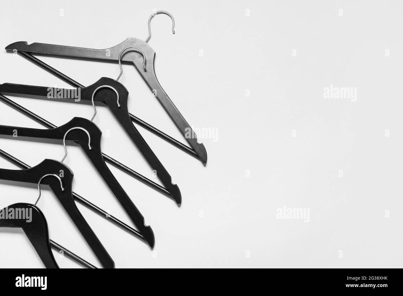 Stylish clothes hangers on light background Stock Photo Alamy