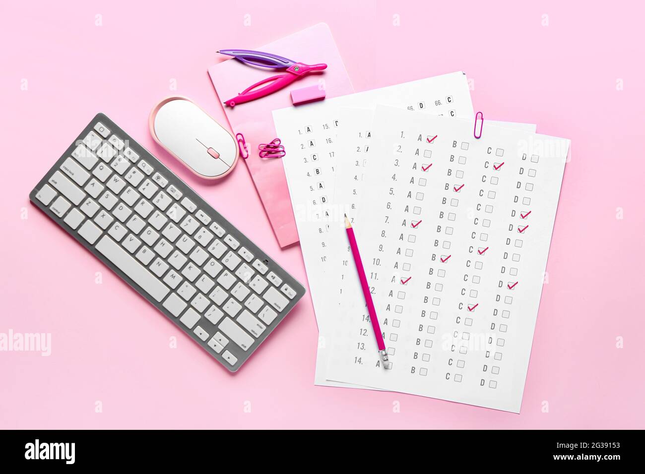 Answer sheets, stationery, computer keyboard and mouse on color background Stock Photo