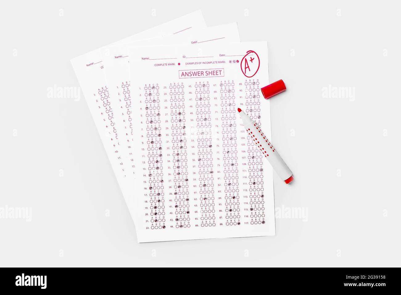 Checked answer sheet and marker on white background Stock Photo Alamy
