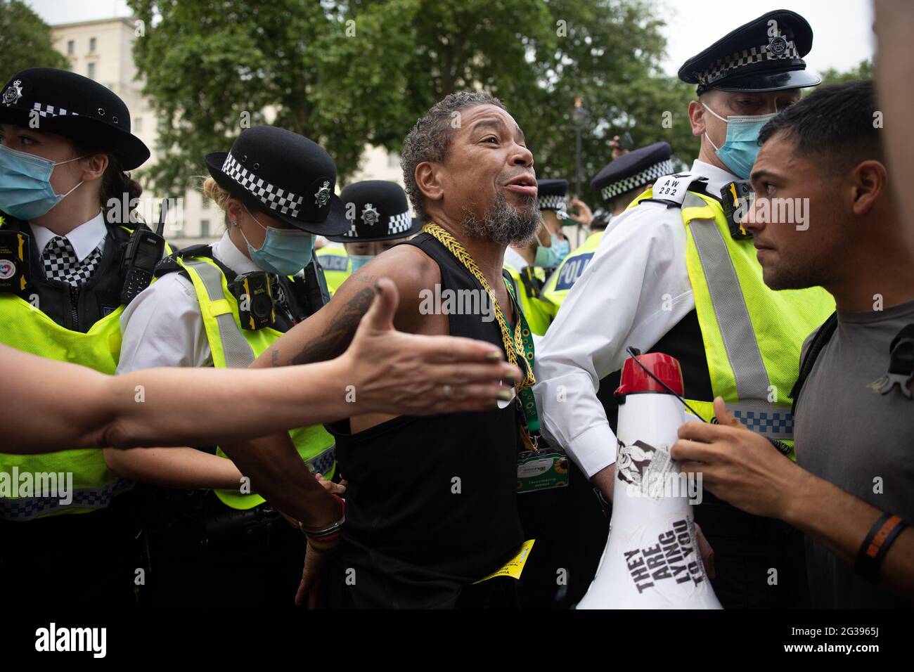 London, UK. 14th June 2021. An anti-vaxx protester is arrested outside Downing Street. Yuen Ching Ng/Alamy Live News. Stock Photo