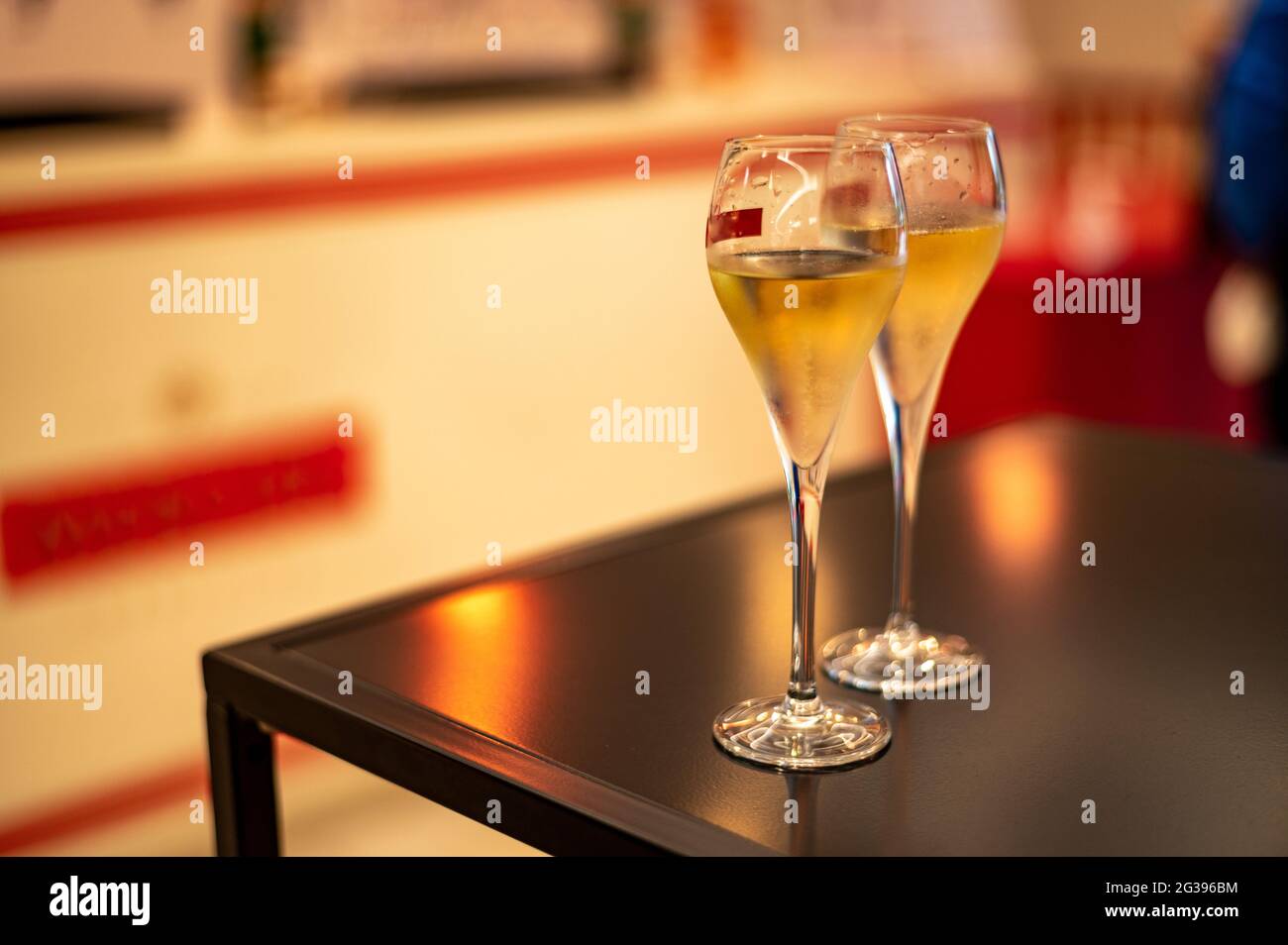 Tasting of cold brut Champagne sparkling wines in underground cellars of wine house in Reims
