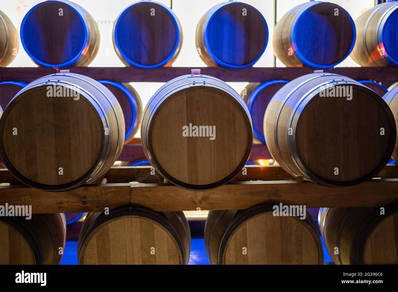 Champagne brut sparkling wine production in oak wooden barrels in dark