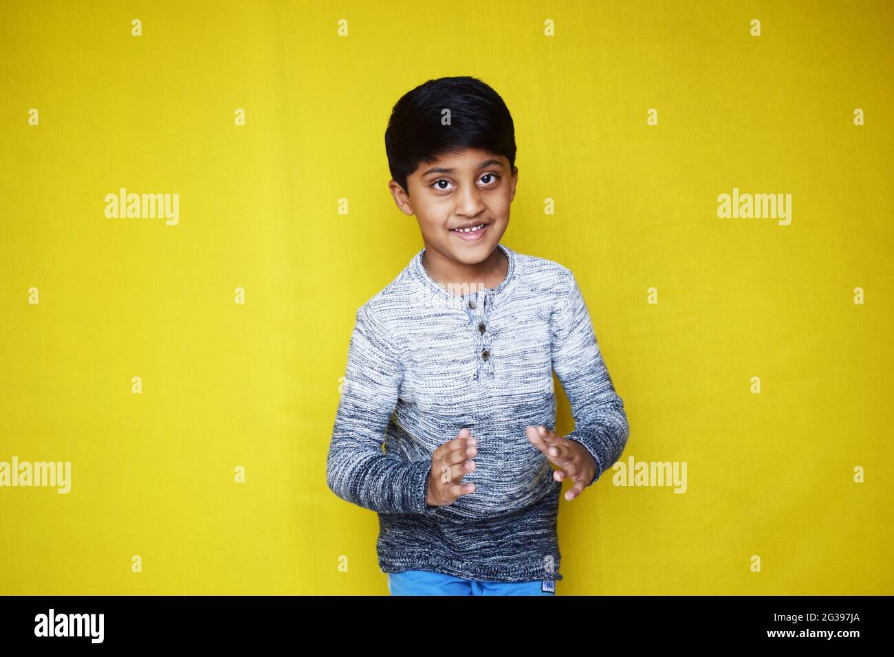 Funny Indian little boy posing on a yellow background Stock Photo Alamy
