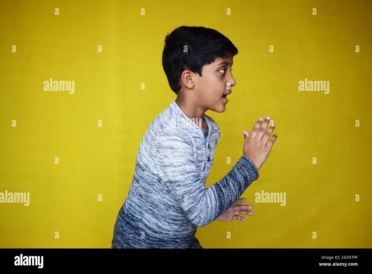 Funny Indian little boy posing on a yellow background Stock Photo Alamy