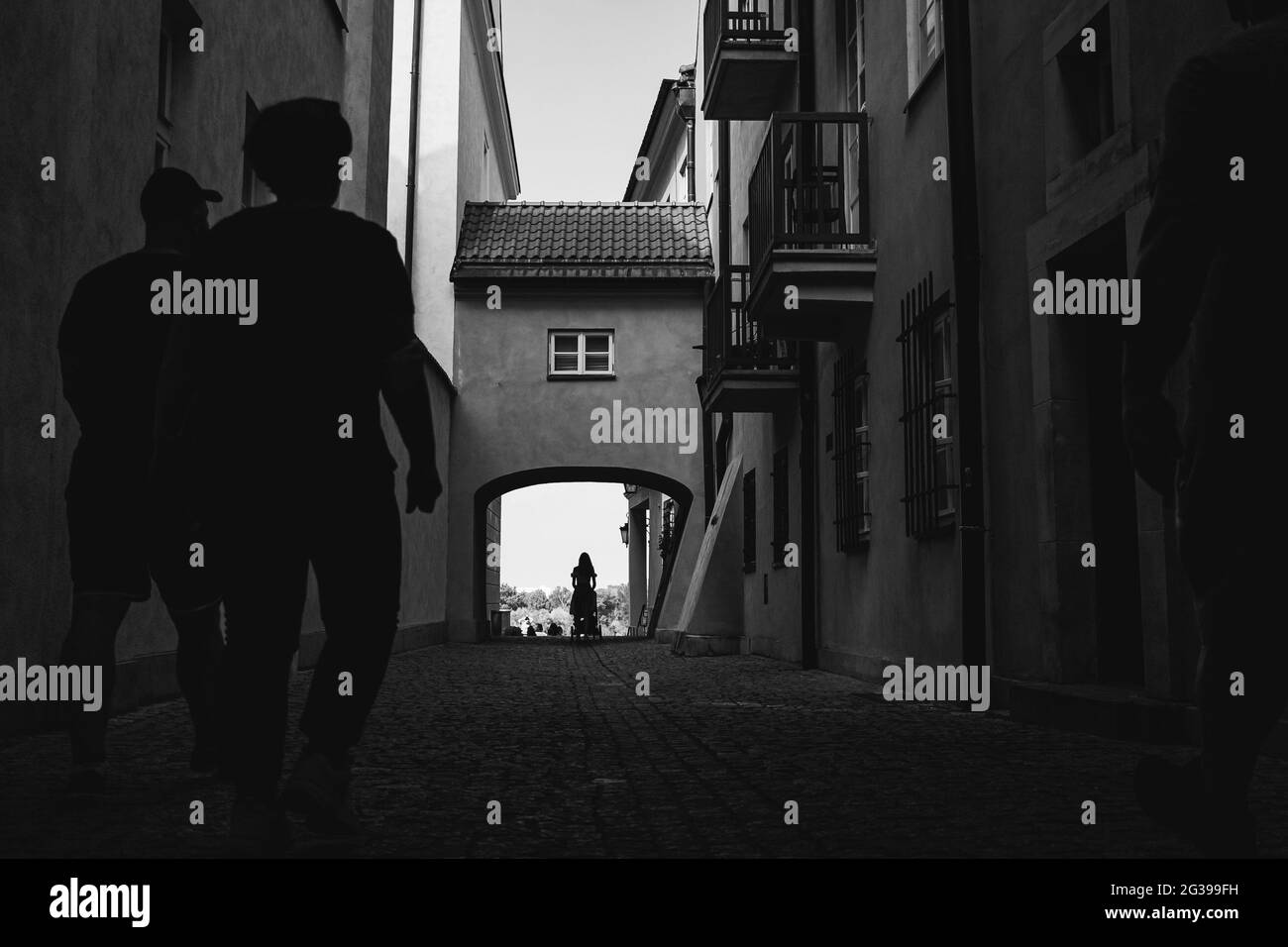 people walking through the small passage between buildings, streets of Warsaw Stock Photo