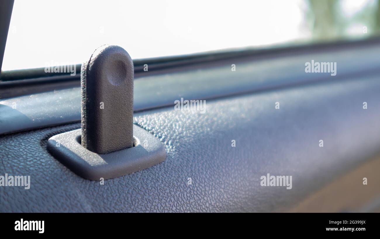Close the lock button for the interior door of the vehicle. Door lock button inside the car
