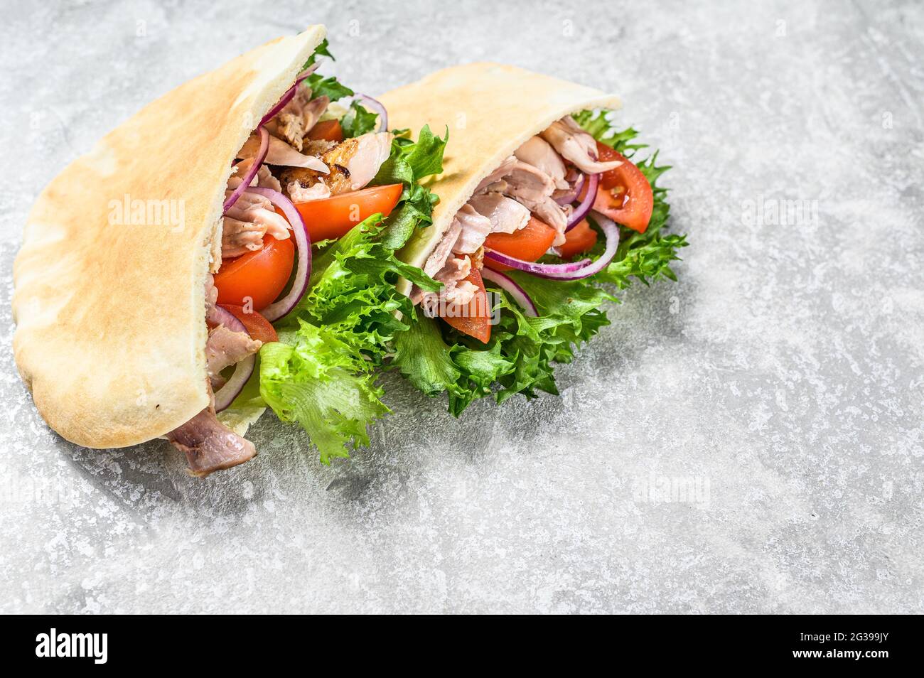 Doner kebab with grilled chicken meat and vegetables in pita bread