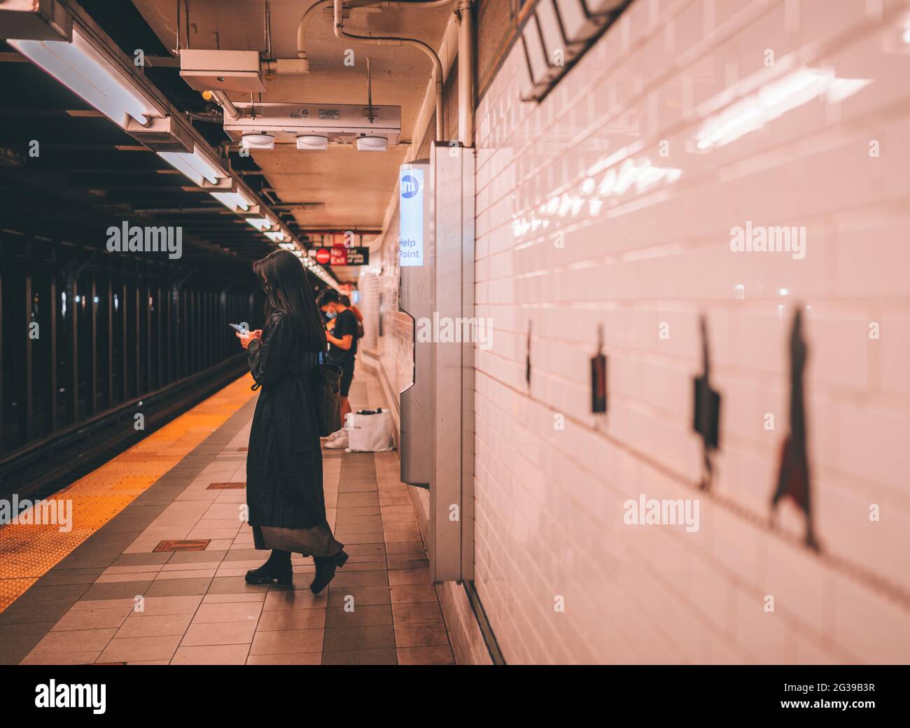 woman subway train cell phone waiting new york city usa Stock Photo