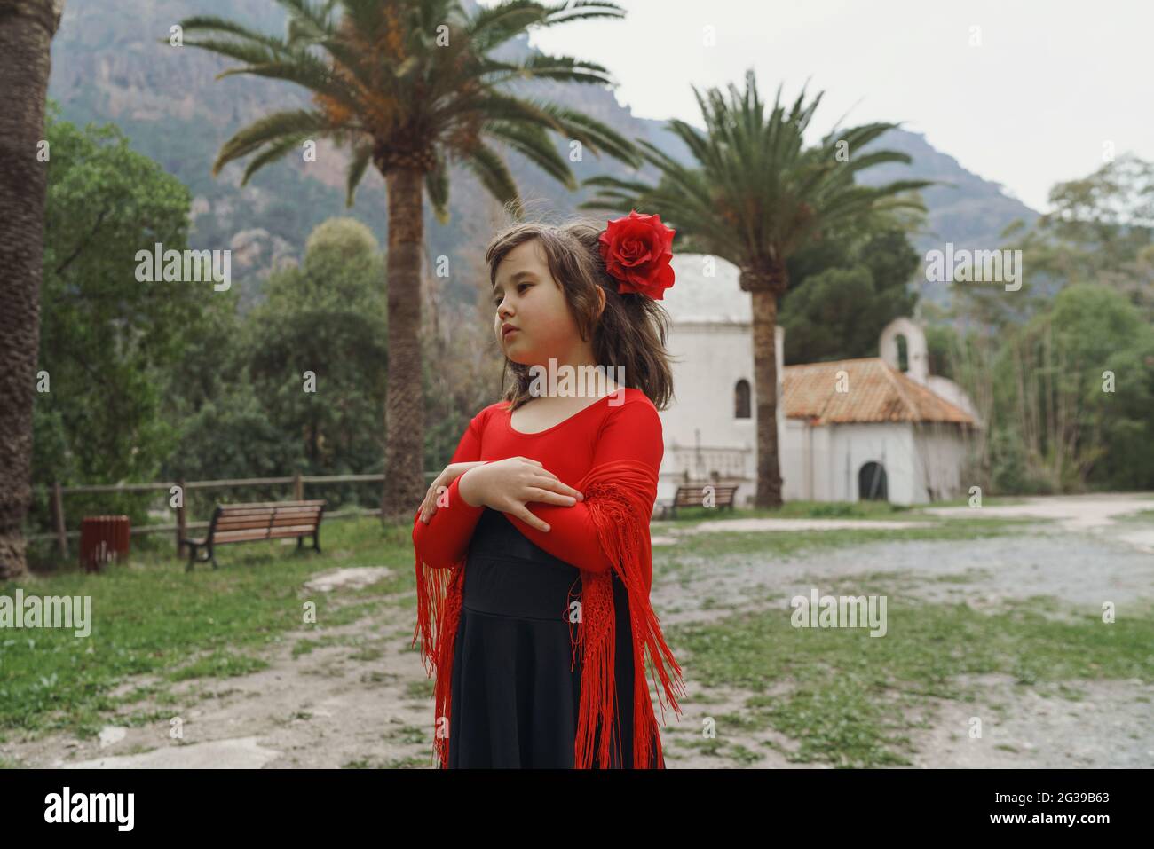 Little girl standing in the garden in Spanish dress Stock Photo Alamy