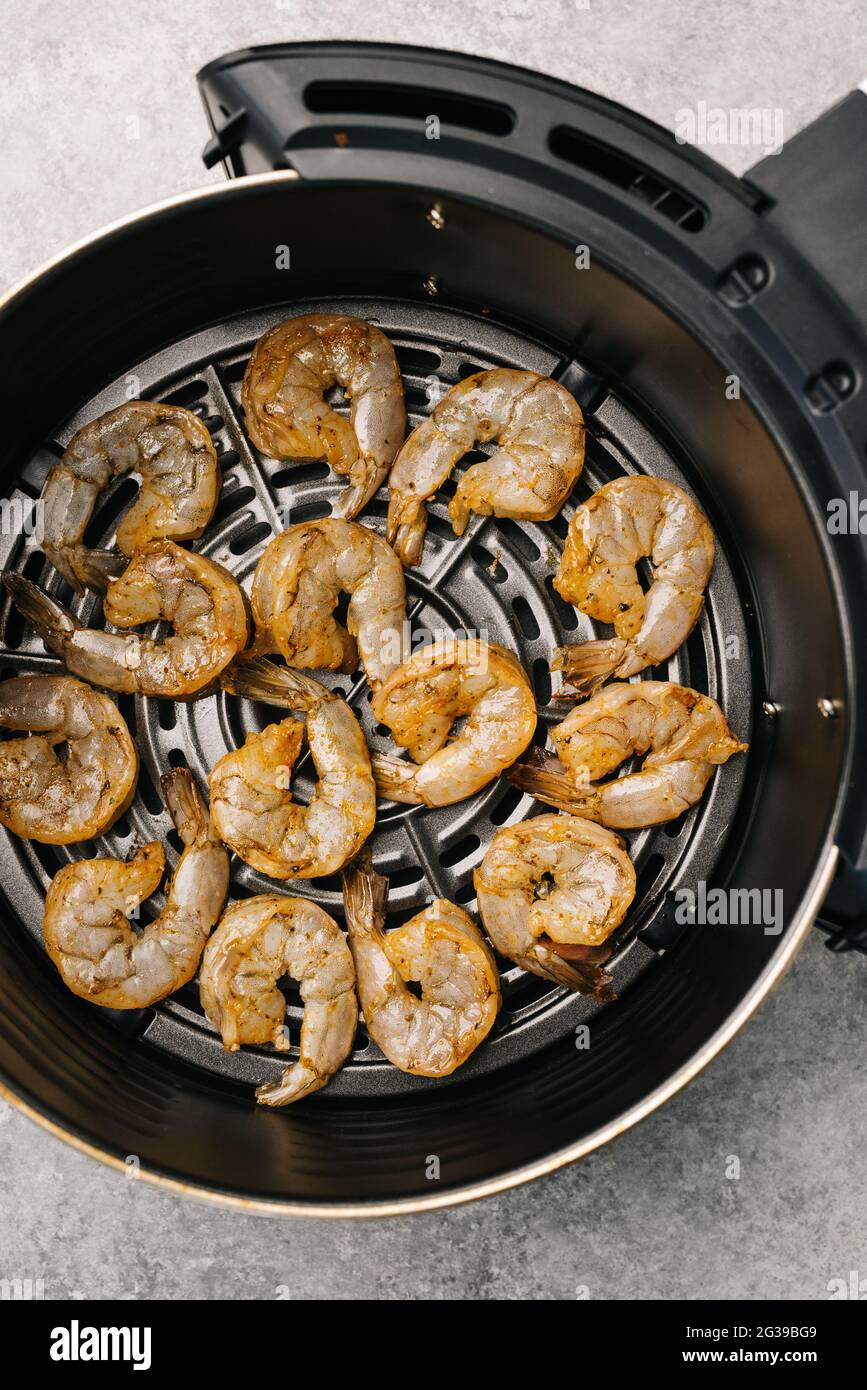 Raw marinated shrimp in an air fryer Stock Photo Alamy