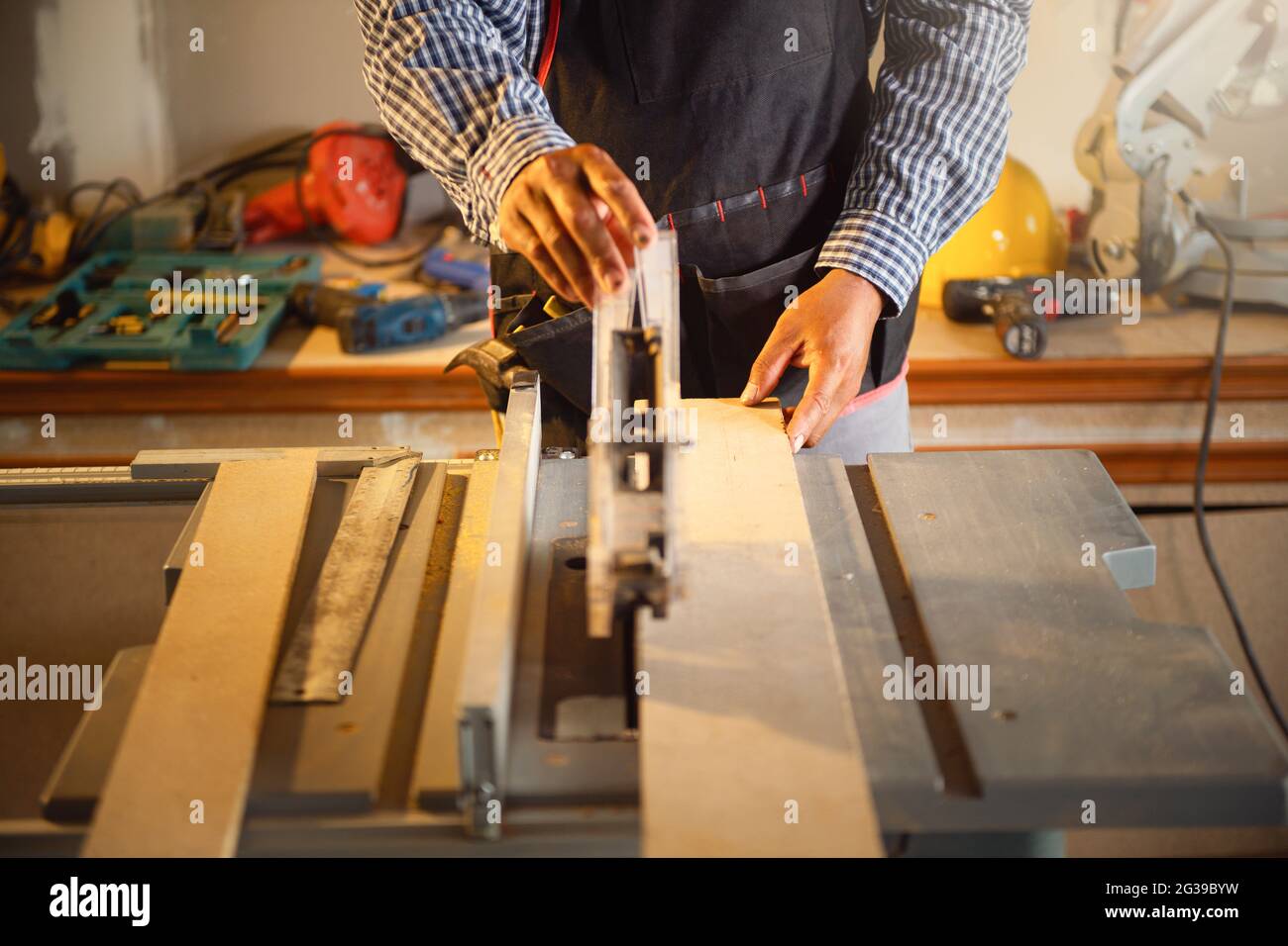 Carpenter working with equipment on wooden table in carpentry Stock Photo