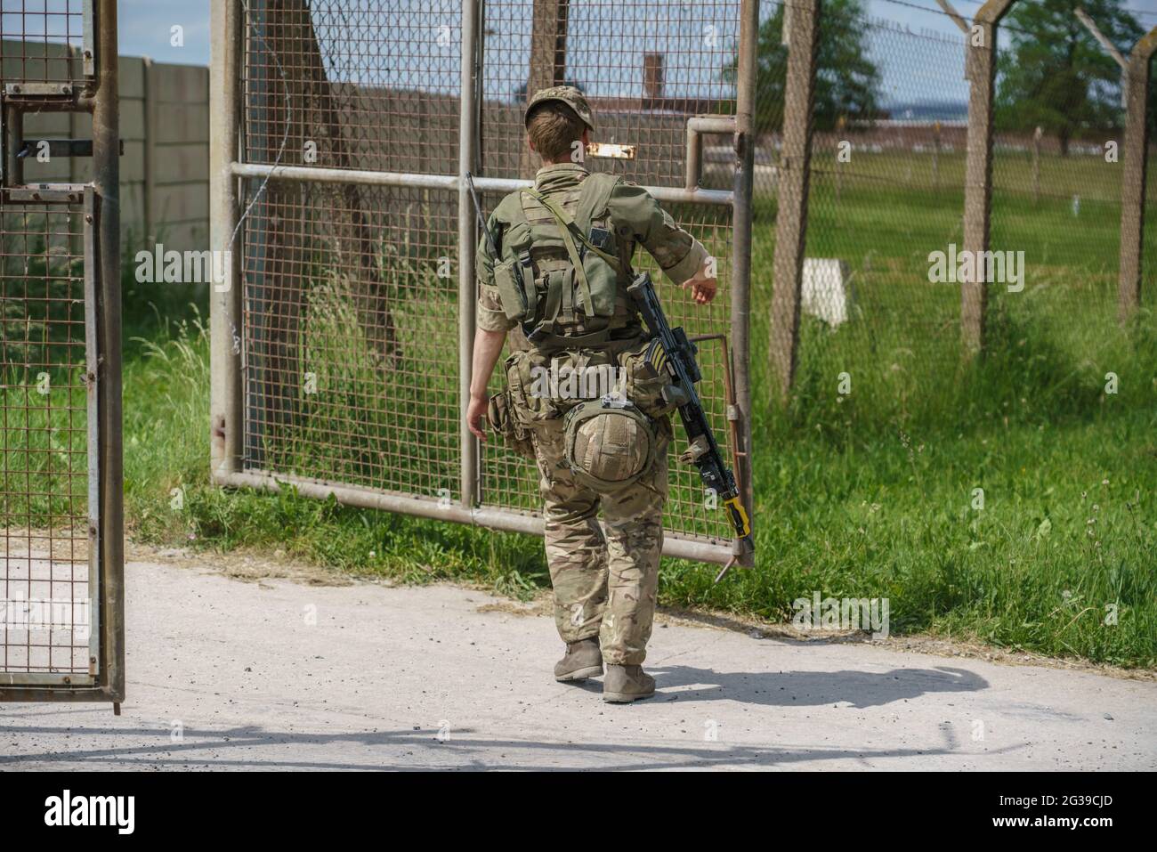 British Army soldier guarding the entrance to a secure base compound on