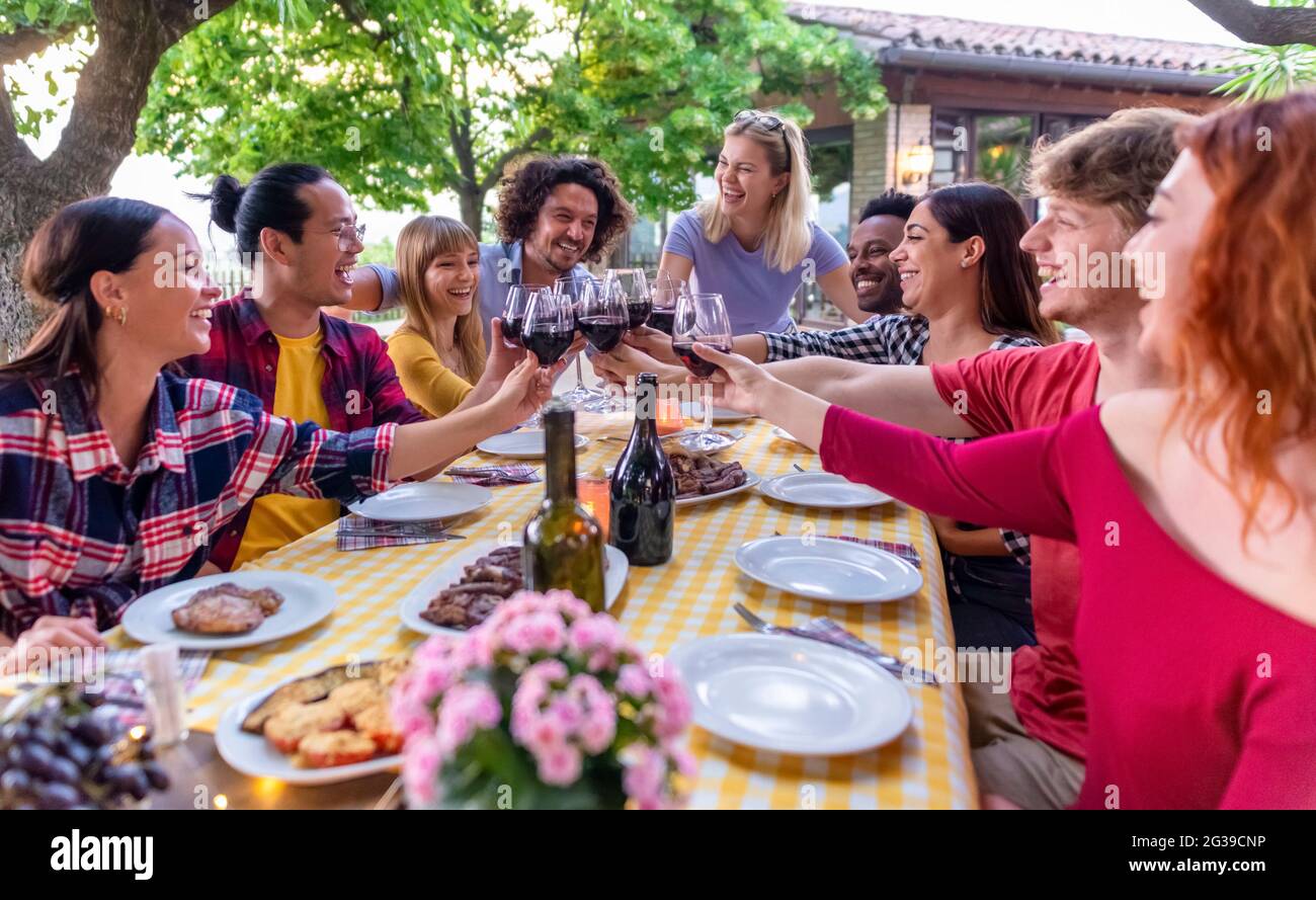 multiethic big group of people enjoying barbecue dinner together