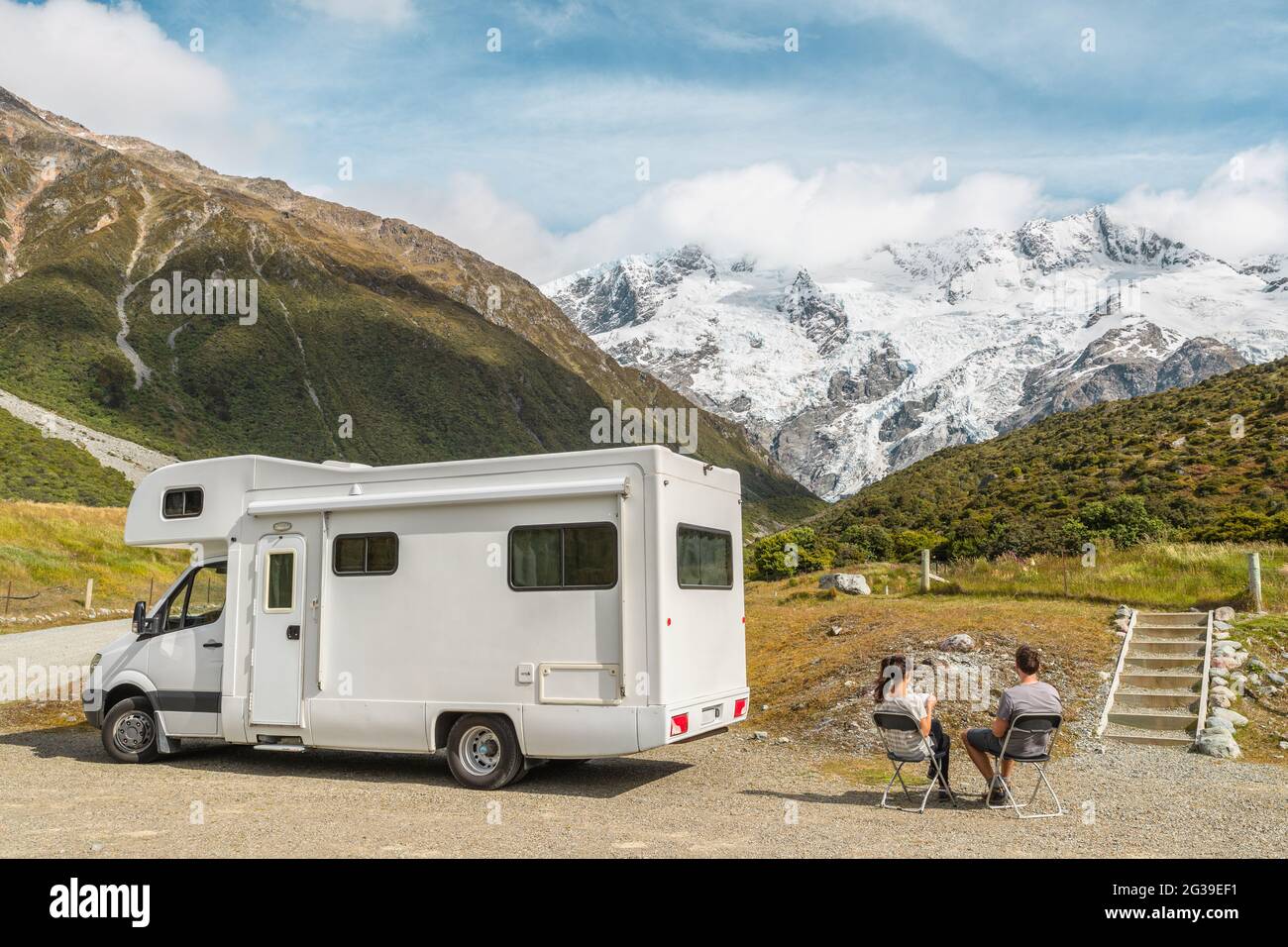 Motorhome camper van RV road trip on New Zealand. Couple on travel vacation adventure. Tourists looking at view of Aoraki Mount Cook National park and Stock Photo