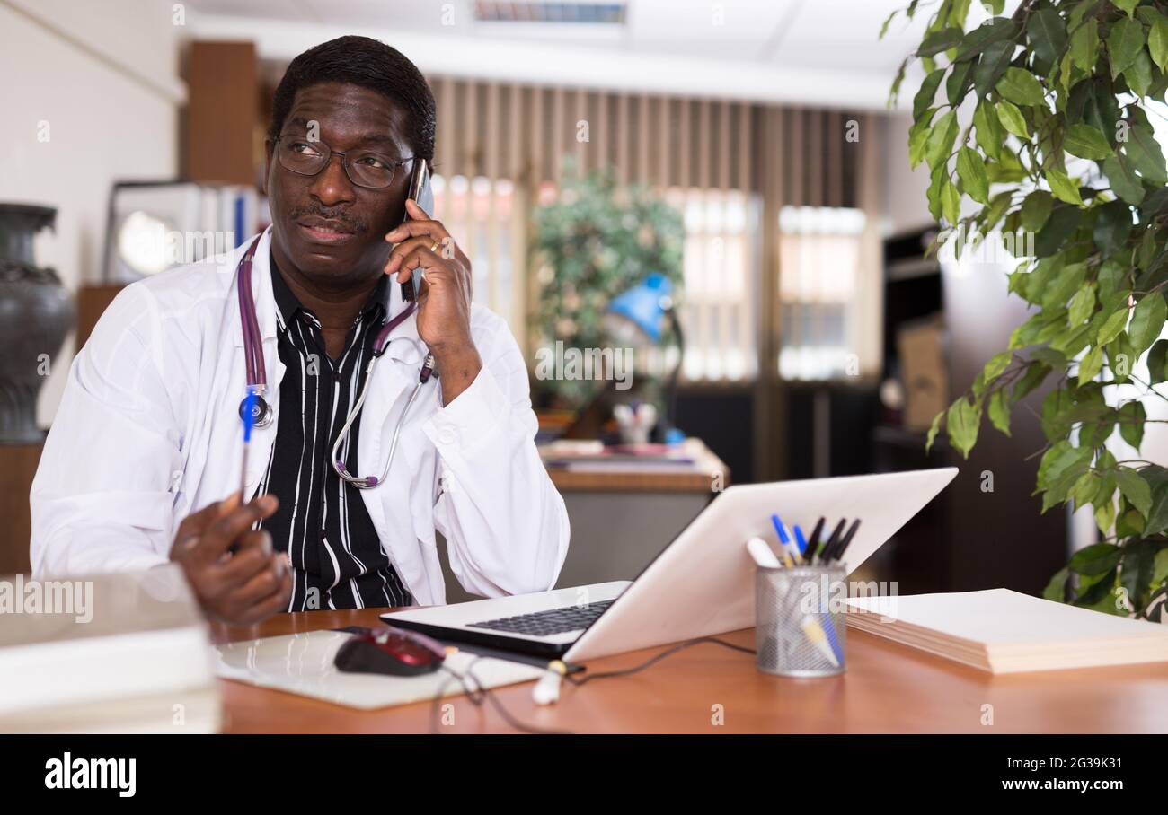 African american doctor conducts hi-res stock photography and images ...