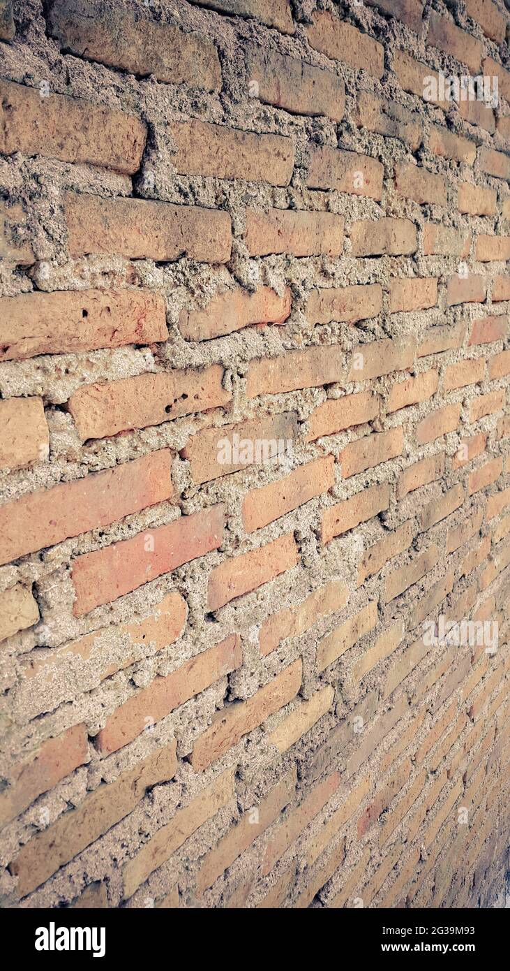 Side view of old orange vintage brick wall background Stock Photo - Alamy