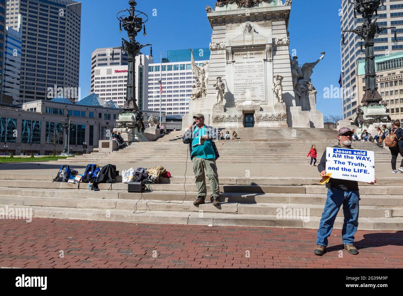 Two street evangelists proclaim the Truth on the steps of the Soldiers and Sailors Monument on Monument Circle in downtown Indianapolis, Indiana, USA. Stock Photo