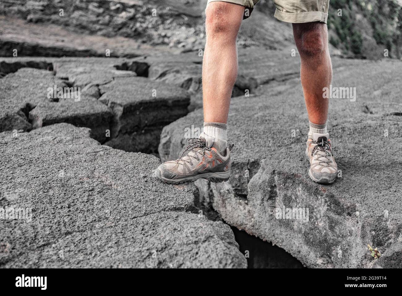 Hiking shoes man hiker on Hawaii island lava rock hike climbing over