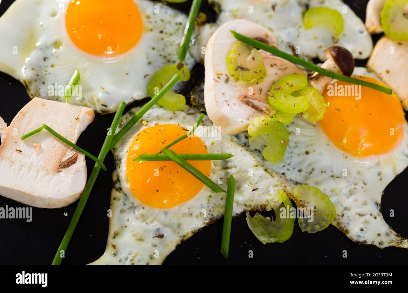Fried quail eggs with champignons Stock Photo