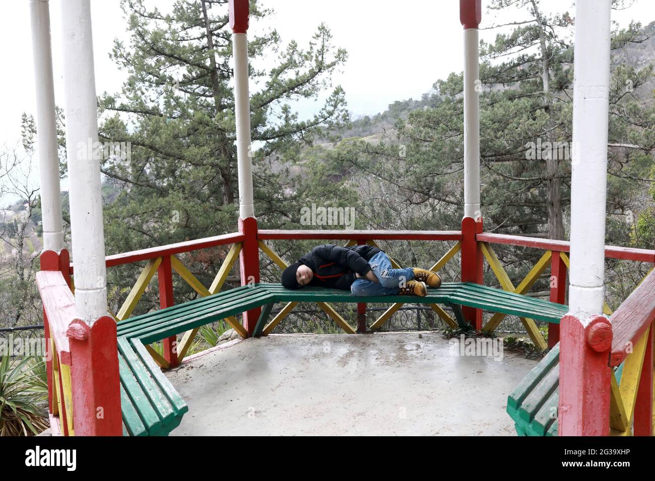 Boy sleeping on park bench hi-res stock photography and images - Alamy