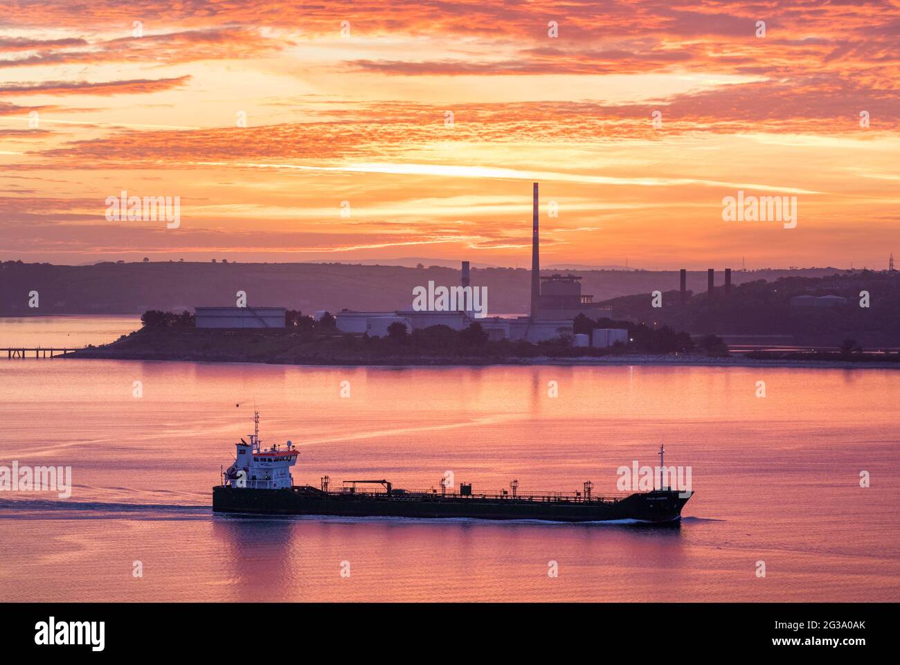 Whitegate, Cork, Ireland. 15th June, 2021.Oil tanker Thun Gemini passes the ESB generating Station in Aghada as she steams out of Cork Harbour bound for Dublin before sunrise. - Credit; David Creedon / Alamy Live News Stock Photo
