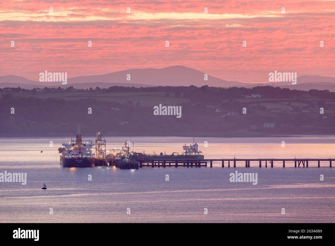 Whitegate, Cork, Ireland. 15th June, 2021. Oil tankers Baltic Swift and Thun Gemini tied up at the Jetty before dawn at the oil refinery in Whitegate, Co. Cork, Ireland. - Credit; David Creedon / Alamy Live News Stock Photo