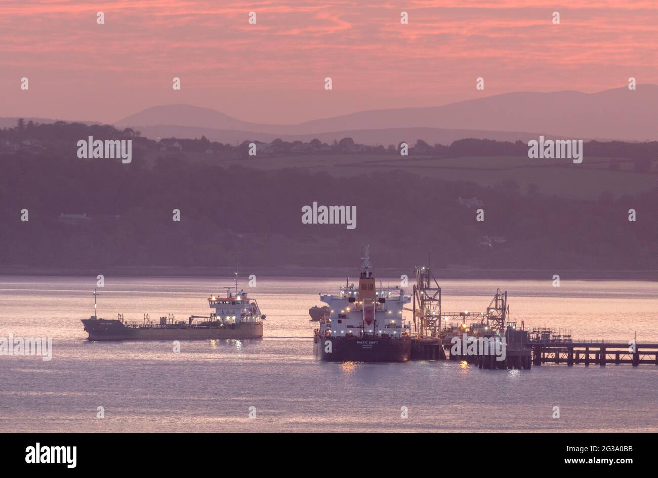 Whitegate, Cork, Ireland. 15th June, 2021.Oil tanker Thun Gemini departing the jetty at the oil refinery before dawn in Whitegate, Co. Cork, Ireland. - Credit; David Creedon / Alamy Live News Stock Photo