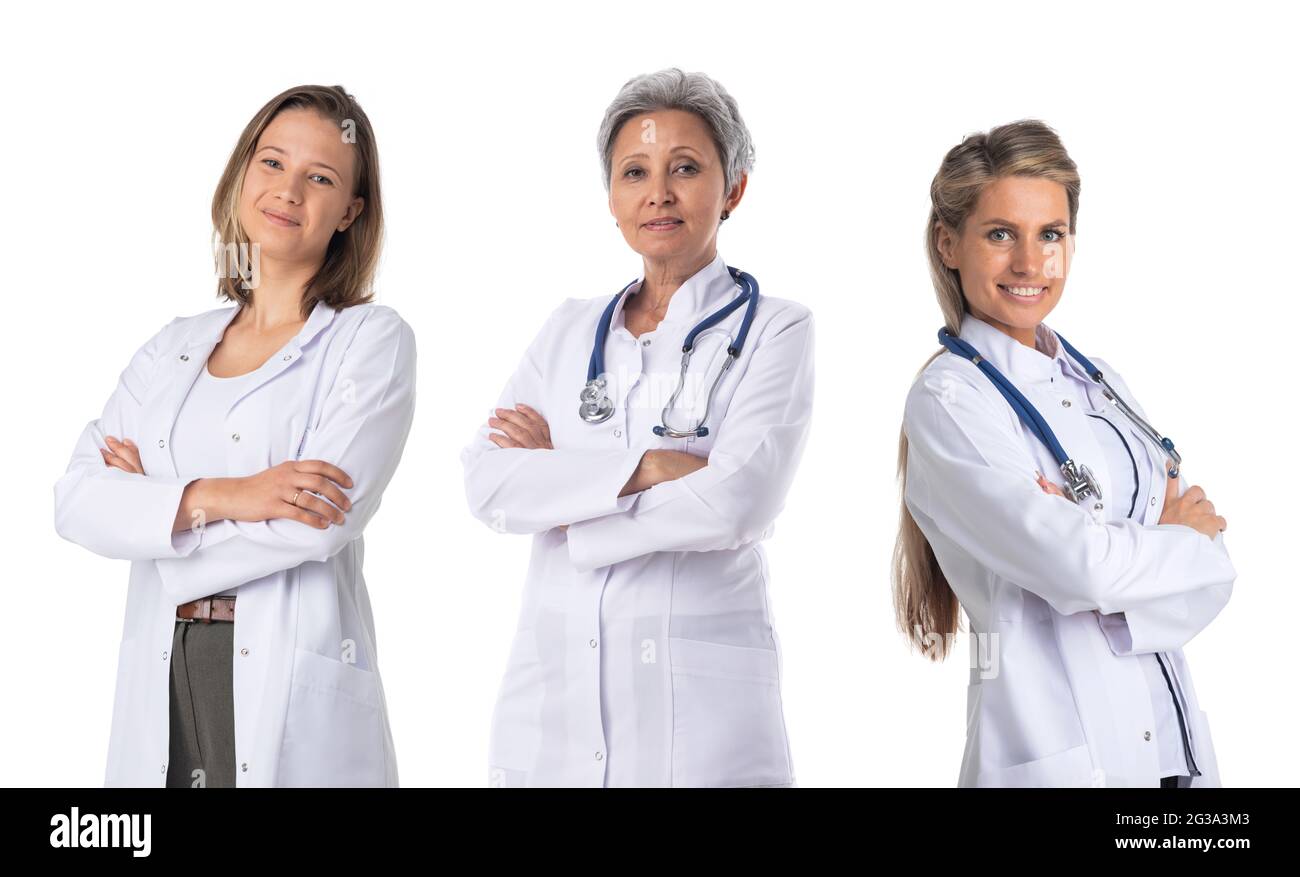 Team of three smiling female medical doctors with stethoscopes in white uniform isolated on white background Stock Photo