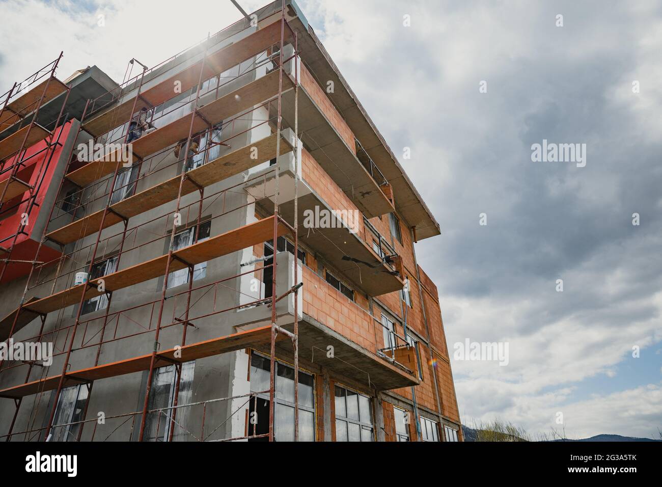 Low angle shot of a residential high rise building under a cloudy sky ...
