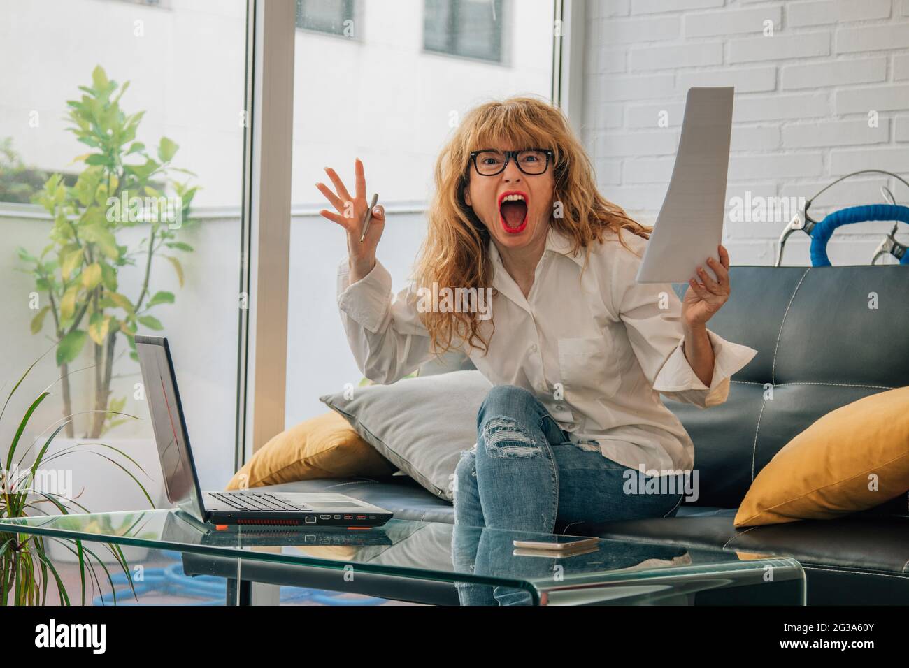 angry woman at home with computer Stock Photo - Alamy